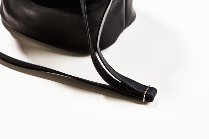 Close up Lederriemen in schwarz einer Handtasche mit Silberschnalle