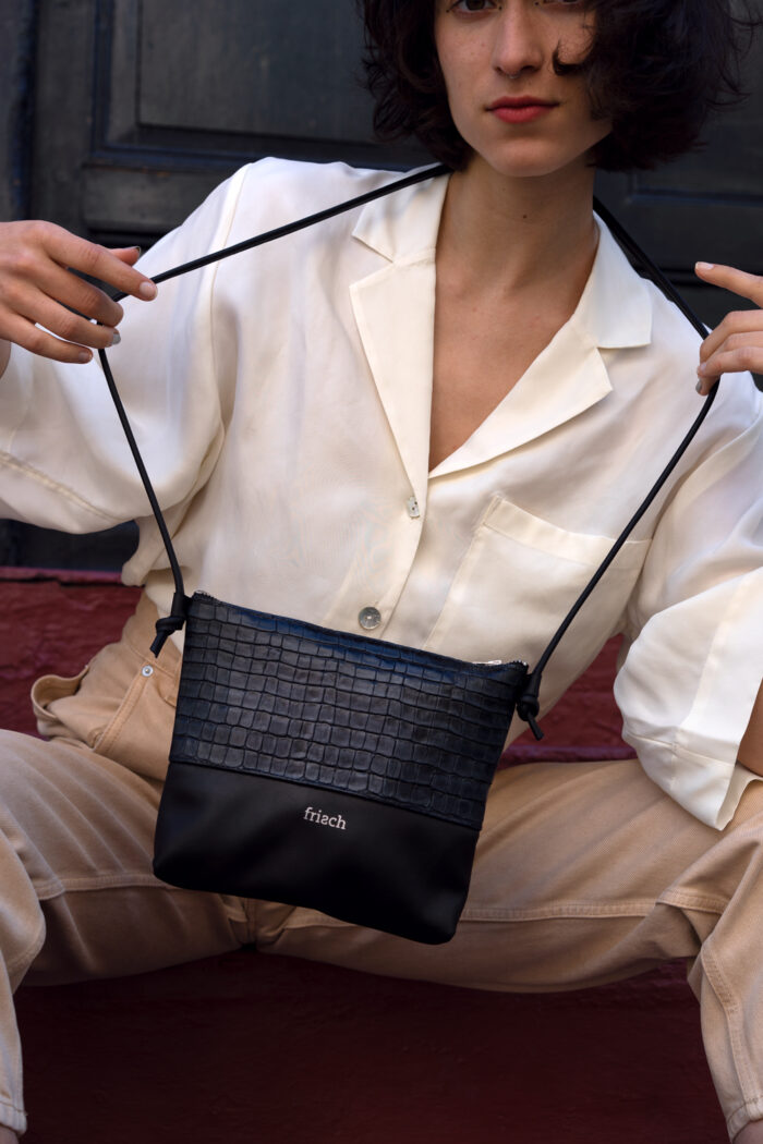 Model mit weißer Bluse und geprägter Handtasche von frisch Beutel in Kroko Optik